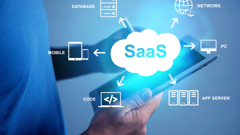 A man holding a tablet with a glowing “SaaS” cloud icon linked to database, network, code and server icons.